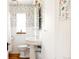 Charming bathroom showcasing floral wallpaper and classic fixtures at 650 Kearney St, Denver, CO 80220