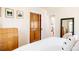 Bright bedroom featuring a white bed, wooden dresser, and stylish decor at 650 Kearney St, Denver, CO 80220