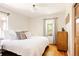 Serene bedroom with hardwood floors, a comfortable bed, and natural light at 650 Kearney St, Denver, CO 80220