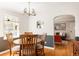 Charming dining area with hardwood floors, a round wooden table, and stylish light fixture at 650 Kearney St, Denver, CO 80220