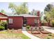 Charming red brick home featuring a walkway, well-kept garden, and a welcoming front entrance at 650 Kearney St, Denver, CO 80220