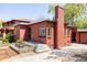 Brick home exterior with well-maintained landscaping and detached garage at 650 Kearney St, Denver, CO 80220