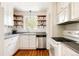 Well-lit kitchen featuring white cabinets, open shelving, and stainless steel appliances at 650 Kearney St, Denver, CO 80220