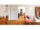 Bright living room featuring hardwood floors, arched doorways, and neutral paint at 650 Kearney St, Denver, CO 80220