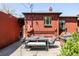 Brick home featuring a cozy backyard patio, grill, and lush landscaping at 650 Kearney St, Denver, CO 80220