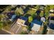 Aerial view of a residential area featuring houses with well-maintained lawns and mature trees at 134 S Quitman St, Denver, CO 80219