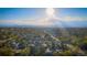 Scenic aerial view showcasing a vibrant cityscape with lush greenery and distant mountains at 134 S Quitman St, Denver, CO 80219