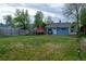 Spacious backyard featuring a lush green lawn and a charming blue home exterior at 134 S Quitman St, Denver, CO 80219