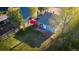 Spacious backyard features a green lawn, wooden fence, patio seating area, and shade trees, perfect for outdoor entertaining at 134 S Quitman St, Denver, CO 80219