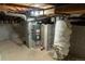 Basement featuring a modern water heater and heater at 134 S Quitman St, Denver, CO 80219