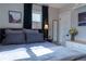 Bright bedroom featuring gray bedding, natural light and a closet, offering a comfortable and functional space at 134 S Quitman St, Denver, CO 80219