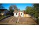 Charming blue home with a red door and a well-manicured gravel front yard at 134 S Quitman St, Denver, CO 80219