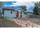 Charming home with a bright red front door, set against a light blue exterior at 134 S Quitman St, Denver, CO 80219