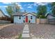 Charming home featuring a well-maintained yard with rock ground cover and a concrete walkway leading to the front door at 134 S Quitman St, Denver, CO 80219