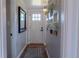 Hallway featuring a stylish mirror and decorative wall art, providing a welcoming entrance to the home at 134 S Quitman St, Denver, CO 80219