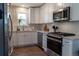 Modern kitchen with white cabinets, stainless steel appliances, and stylish subway tile backsplash at 134 S Quitman St, Denver, CO 80219