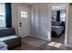 Living room entrance showcasing a white door and a partial view of a bedroom with modern decor at 134 S Quitman St, Denver, CO 80219