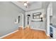 Dining area featuring beautiful hardwood floors, arched doorway, and stylish mirror at 3818 W 25Th Ave, Denver, CO 80211