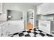 Quaint kitchen featuring black and white tile flooring and vintage appliances at 3818 W 25Th Ave, Denver, CO 80211