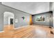 Inviting living room featuring hardwood floors, stylish lighting, and large window at 3818 W 25Th Ave, Denver, CO 80211
