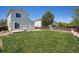Spacious backyard with a well-kept lawn, patio, and privacy fence, perfect for outdoor enjoyment at 1232 Bluebird St, Brighton, CO 80601