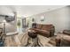 Open-concept living room with modern flooring, a comfortable sofa, and seamless access to the dining area at 1232 Bluebird St, Brighton, CO 80601