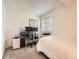 This bedroom setup includes a desk with multiple monitors, and a well lit window at 13645 E Yale Ave # C, Aurora, CO 80014
