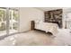 Bright bedroom features a stone fireplace, carpet floors, and sliding glass doors at 13645 E Yale Ave # C, Aurora, CO 80014