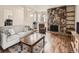 Cozy living room features a stone fireplace, hardwood floors, and comfortable seating at 13645 E Yale Ave # C, Aurora, CO 80014