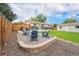 Spacious backyard featuring a new fence, comfortable patio set, and fire pit at 6513 Gray St, Arvada, CO 80003