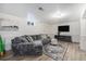 Basement living area with modern flooring, large sectional sofa, and media setup at 6513 Gray St, Arvada, CO 80003