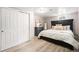 Cozy bedroom with light wood flooring, closet, large bed, and stylish decor at 6513 Gray St, Arvada, CO 80003