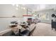 Bright dining room with modern lighting, a cozy fireplace, and backyard views at 6513 Gray St, Arvada, CO 80003