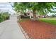 Traditional home with a detached garage, mature trees, lawn and an inviting driveway at 6513 Gray St, Arvada, CO 80003