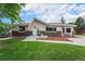 Charming single-story home with a well-maintained lawn, mature trees, and appealing curb appeal at 6513 Gray St, Arvada, CO 80003