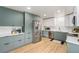 Modern kitchen featuring stainless steel appliances, two-tone cabinets, and a white subway tile backsplash at 6513 Gray St, Arvada, CO 80003