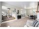 Spacious, carpeted living room and dining area, with sightlines to the living room and backyard at 6513 Gray St, Arvada, CO 80003