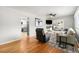 Cozy living room with hardwood floors, ceiling fan, and fireplace, adjoined to the kitchen area at 6513 Gray St, Arvada, CO 80003