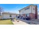 Home backyard with patio, outdoor seating, grill, and a well-maintained lawn at 1941 E 119Th Pl, Northglenn, CO 80233