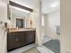 Bathroom featuring a vanity with a wooden framed mirror, sink and cabinet storage at 1941 E 119Th Pl, Northglenn, CO 80233