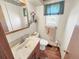 Well-lit bathroom featuring a wood vanity and a window bringing in natural light at 1941 E 119Th Pl, Northglenn, CO 80233