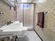 Compact bathroom featuring a stall shower with textured walls and frosted glass at 1941 E 119Th Pl, Northglenn, CO 80233