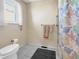 Bathroom with tiled floor, patterned shower curtain and a neutral color scheme at 1941 E 119Th Pl, Northglenn, CO 80233