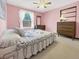 Bright bedroom features a floral-patterned bedspread and a window with sheer curtains at 1941 E 119Th Pl, Northglenn, CO 80233