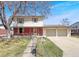 Charming two-story home with a brick facade, landscaped yard, and a spacious two-car garage at 1941 E 119Th Pl, Northglenn, CO 80233