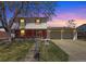 Charming two-story home with a brick facade, landscaped yard, and a spacious two-car garage at 1941 E 119Th Pl, Northglenn, CO 80233
