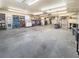 Large garage features open space, storage shelving, and overhead lighting at 1941 E 119Th Pl, Northglenn, CO 80233