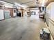 Large garage featuring plenty of storage space, a brick accent wall and overhead lighting at 1941 E 119Th Pl, Northglenn, CO 80233