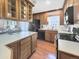 Traditional kitchen with wooden cabinets, modern appliances, and a breakfast bar with seating at 1941 E 119Th Pl, Northglenn, CO 80233