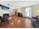 Bright living room featuring hardwood floors, a fireplace, and comfortable furniture at 1941 E 119Th Pl, Northglenn, CO 80233